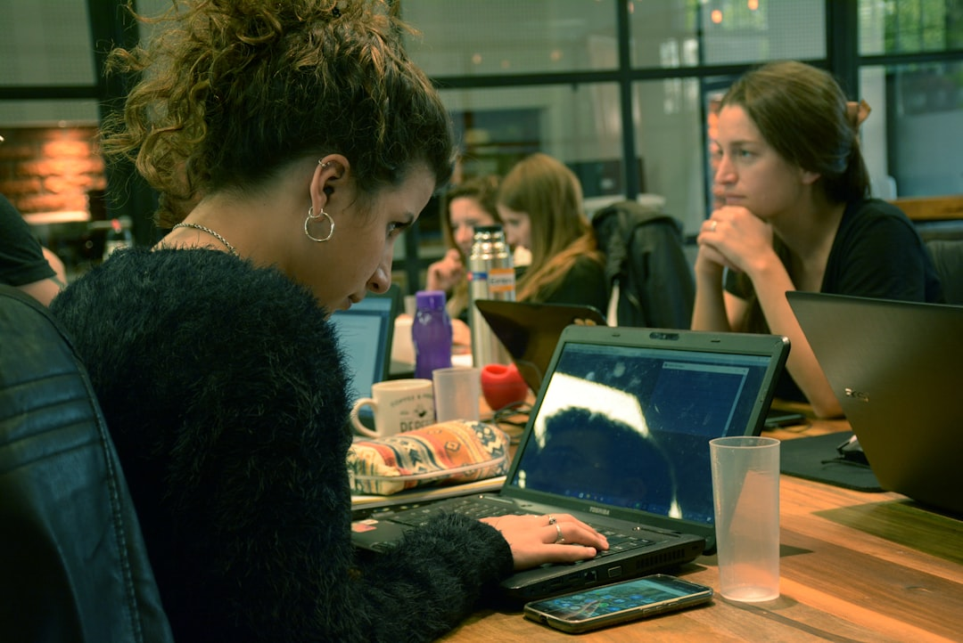 people collaborating at a desk with laptop and documents