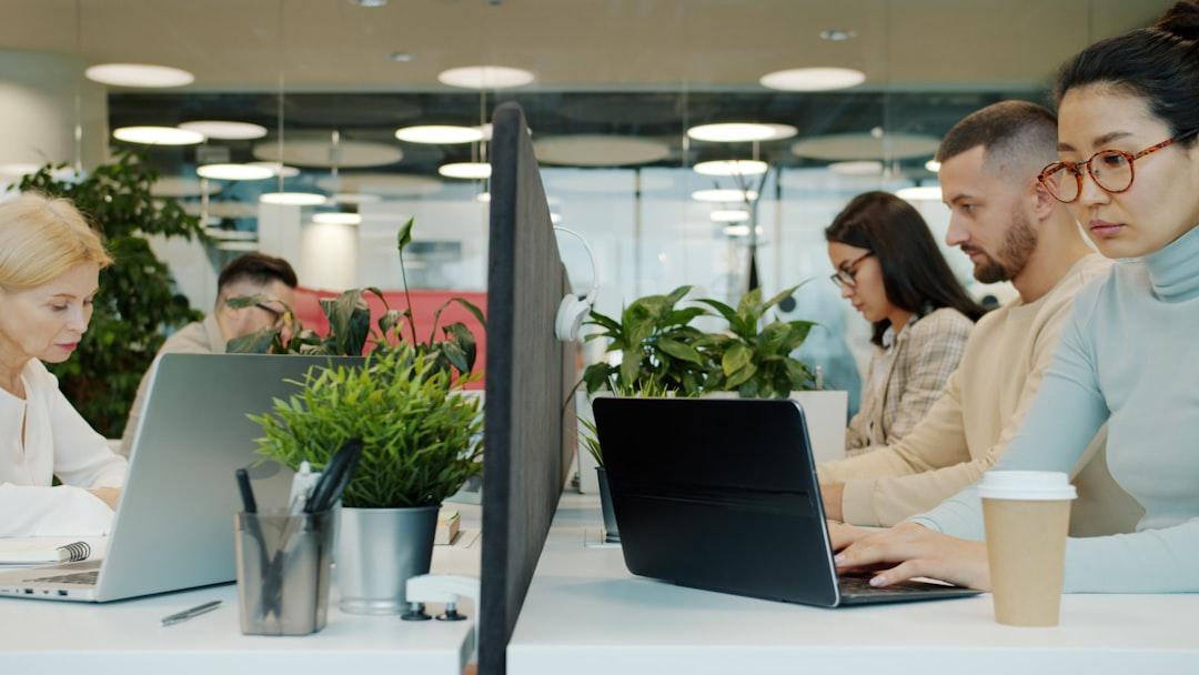 team collaborating on laptops in a modern office